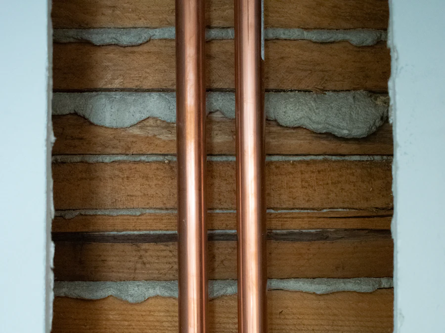 Two new copper pipes running neatly up an exposed wall